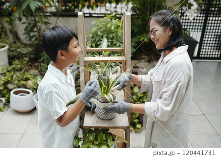 Enjoying Gardening Together in a Backyard Enjoying Gardening Together in a Backyard 120441731
