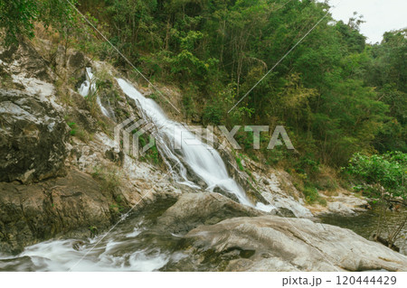 waterfall in summer scene, bright sunrise shining on the waterfall waterfall in summer scene, bright sunrise shining on the waterfall 120444429