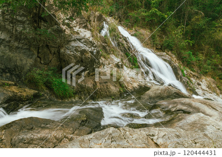 waterfall in summer scene, bright sunrise shining on the waterfall 120444431