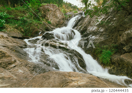 waterfall in summer scene, bright sunrise shining on the waterfall 120444435
