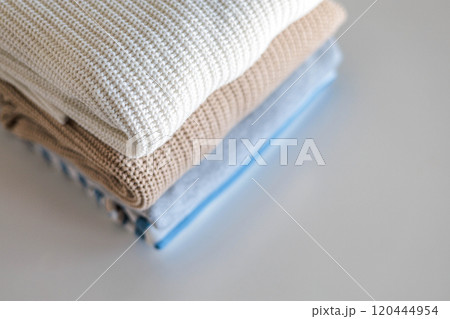 Neatly folded warm knitted sweater stack clothes storage top view isolated on white 120444954