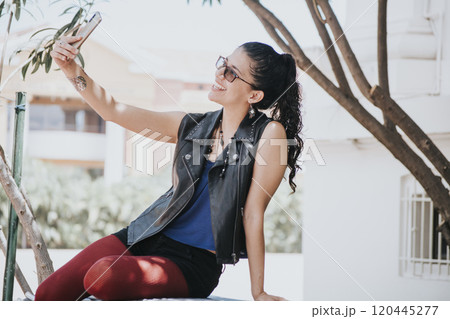 Close-up of a girl taking a selfie, urban girl taking a selfie outdoors, lifestyle woman smiling and taking a selfie Close-up of a girl taking a selfie, urban girl taking a selfie outdoors, lifestyle woman smiling and taking a selfie 120445277