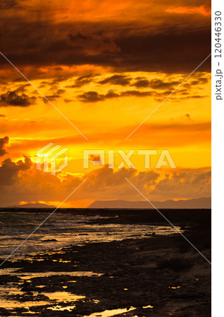 Sunset over sea surface, dark clouds. 120446330