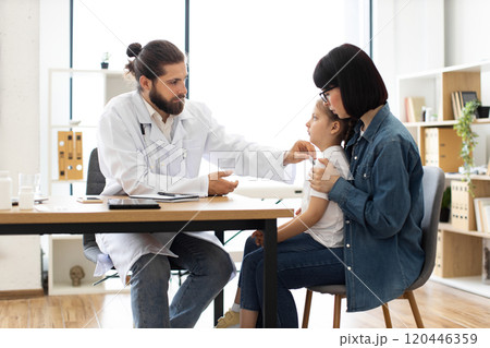Doctor checks temperature of sick child during medical visit Doctor checks temperature of sick child during medical visit 120446359