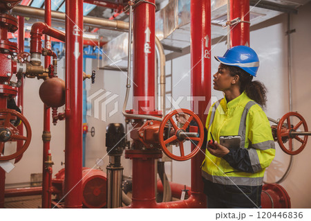 Engineer or technician work checking Fire suppression system and fire equipment. Engineer check red generator pump for water sprinkler piping and fire alarm control system Engineer or technician work checking Fire suppression system and fire equipment. Engineer check red generator pump for water sprinkler piping and fire alarm control system 120446836