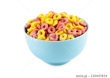 Colorful cereal loop rings on blue bowl isolated on white background. Breakfast food. Colorful cereal loop rings on blue bowl isolated on white background. Breakfast food. 120447654