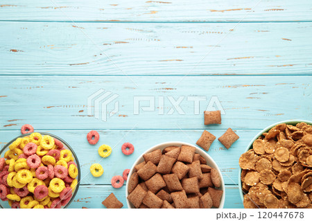 Variety of cereals in blue bowls, quick breakfast on blue wooden background. Vertical photo Variety of cereals in blue bowls, quick breakfast on blue wooden background. Vertical photo 120447678