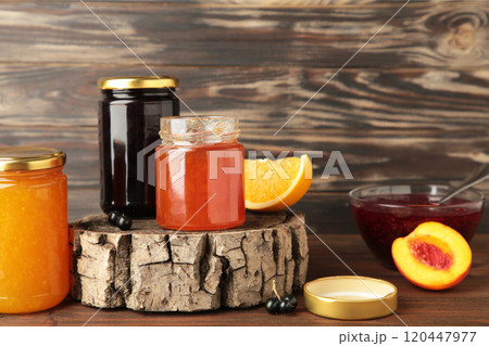 Homemade fruit jam in the jar on brown background. Top view Homemade fruit jam in the jar on brown background. Top view 120447977