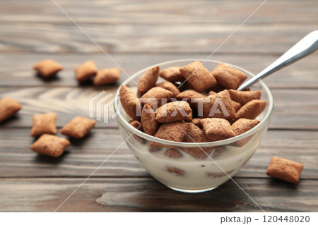 Bowl with chocolate pads on brown background Bowl with chocolate pads on brown background 120448020
