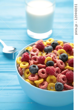 Breakfast with corn flakes, milk and berry on blue background. 120448031