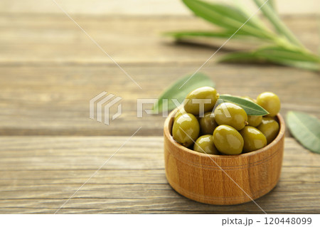 Fresh olives in bowl with leaves on grey background. Fresh olives in bowl with leaves on grey background. 120448099
