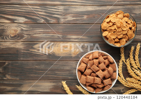 Crispy corn flakes on a brown background. Crispy corn flakes on a brown background. 120448184