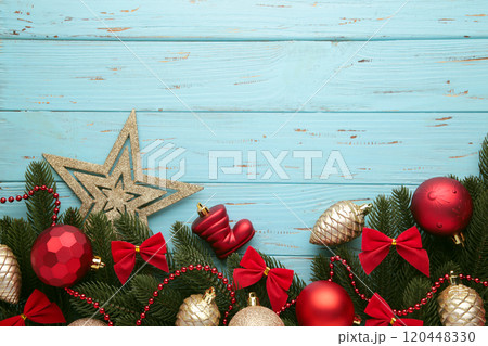 Christmas frame - tree branches with red and gold baubles, stars, snowflakes on blue background. Christmas frame - tree branches with red and gold baubles, stars, snowflakes on blue background. 120448330