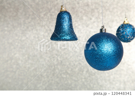 Shiny blue Christmas ball on glittering background Shiny blue Christmas ball on glittering background 120448341