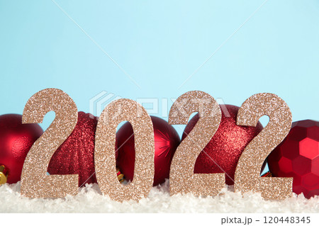 Christmas background with Christmas balls and numerals 2022. New Year concept on blue. 120448345
