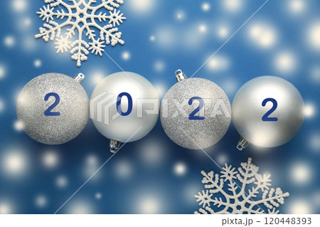 Inscription 2022 on christmas balls on blue background Inscription 2022 on christmas balls on blue background 120448393