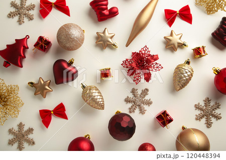 Gold and red Christmas decoration on white background, top view, flat lay Gold and red Christmas decoration on white background, top view, flat lay 120448394