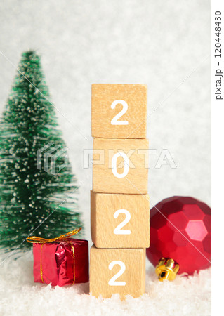 Christmas background with fir trees and Christmas decorations and numerals 2022. New Year concept on silver background. Christmas background with fir trees and Christmas decorations and numerals 2022. New Year concept on silver background. 120448430