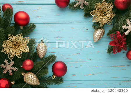 Red and gold Christmas toys decoration on blue background with copy space. New Year greeting card. Minimal style. Flat lay. Red and gold Christmas toys decoration on blue background with copy space. New Year greeting card. Minimal style. Flat lay. 120448560