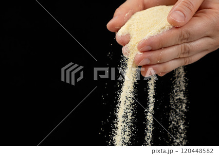 Hands pouring dry semolina durum flour black background copy space for text Hands pouring dry semolina durum flour black background copy space for text 120448582