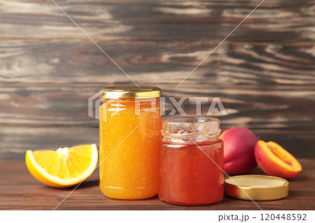 Homemade fruit jam in the jar on brown background. Top view Homemade fruit jam in the jar on brown background. Top view 120448592