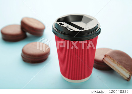Choco pie chocolate coated snacks with cup of coffee on blue background. 120448823