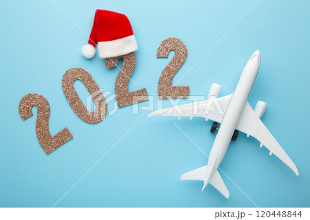 Christmas background with airplane and inscription 2022. Christmas holiday Christmas background with airplane and inscription 2022. Christmas holiday 120448844