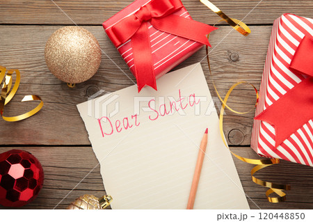 Letter to Santa Claus with Christmas decoration on grey wooden background. Inscription Dear Santa Letter to Santa Claus with Christmas decoration on grey wooden background. Inscription Dear Santa 120448850