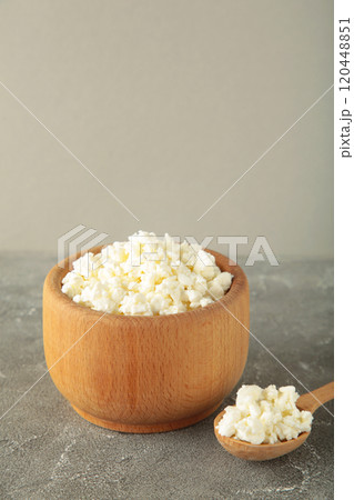 Cottage cheese for breakfast in wooden bowl on grey background. Cottage cheese for breakfast in wooden bowl on grey background. 120448851