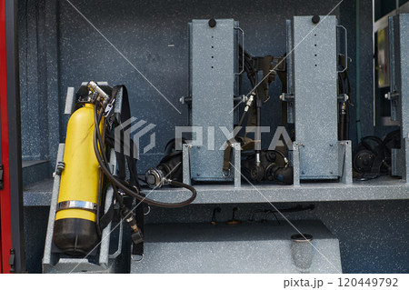 Close-up of essential firefighting equipment on a modern firetruck, showcasing tools and gear ready for emergency response to hazardous fire situations Close-up of essential firefighting equipment on a modern firetruck, showcasing tools and gear ready for emergency response to hazardous fire situations 120449792