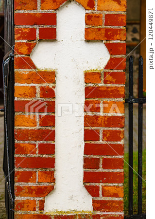 cross on brick wall of the old church cross on brick wall of the old church 120449871