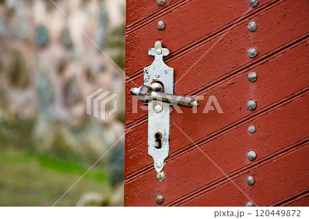 Old vintage wooden doors with metal rivets Old vintage wooden doors with metal rivets 120449872