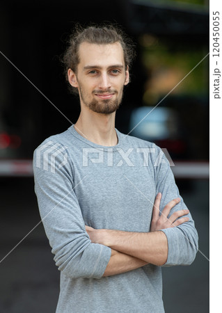 Portrait of a young successful businessman with crossed arms in front of the company Portrait of a young successful businessman with crossed arms in front of the company 120450055