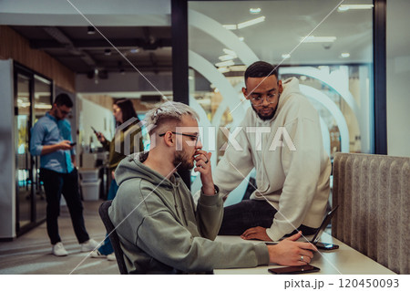 Young group of business people brainstorming together in a startup space, discussing business projects, investments, and solving challenges. 120450093