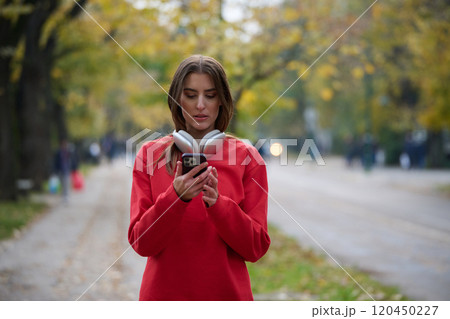 Athletic young woman taking a breath and relaxing after jogging and stretching. Woman Training and Workout Exercises On Street. 120450227