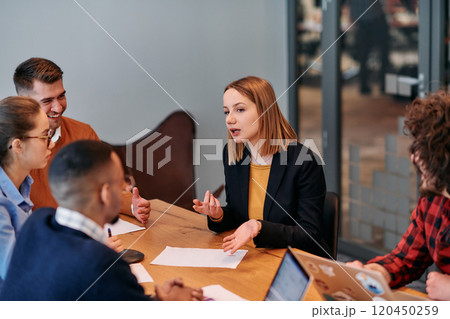 In the vibrant ambiance of a modern startup office, a diverse team of business professionals engage in discussions on various projects and develop new business strategies, epitomizing creativity and In the vibrant ambiance of a modern startup office, a diverse team of business professionals engage in discussions on various projects and develop new business strategies, epitomizing creativity and 120450259