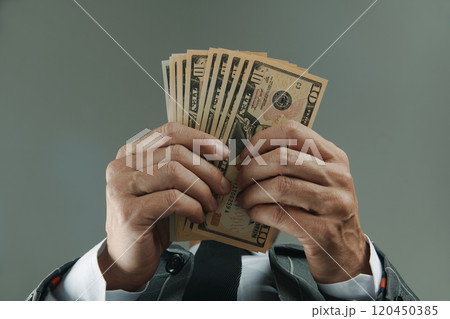 businessman with some dollars, seen from below 120450385