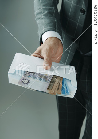 businessman offers an envelope with forints 120450386