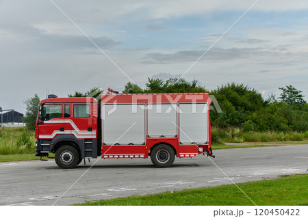 In this captivating scene, a state-of-the-art firetruck, equipped with advanced rescue technology, stands ready with its skilled firefighting team, prepared to intervene and respond rapidly to In this captivating scene, a state-of-the-art firetruck, equipped with advanced rescue technology, stands ready with its skilled firefighting team, prepared to intervene and respond rapidly to 120450422
