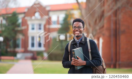 happy african american student with books in his hands against the background of the university campus happy african american student with books in his hands against the background of the university campus 120450460