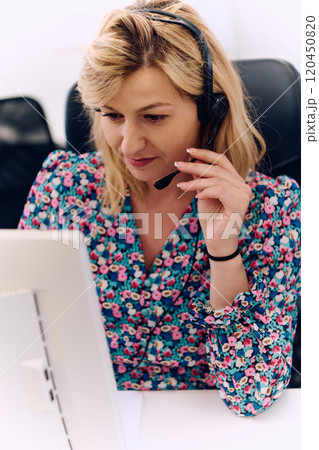 Friendly Call Center Agent Answering Incoming Calls with Headset Providing Remote Customer Service. 120450820