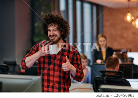Focused Professional: Interesting Man with Coffee Cup in Office Surrounded by Computers. 120450963