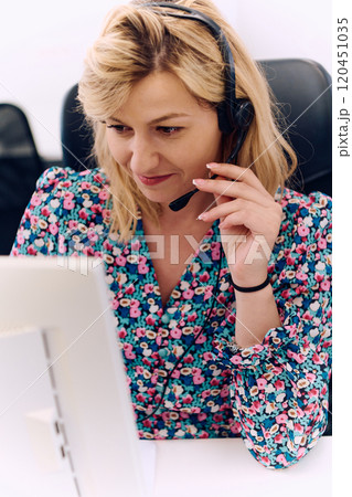 Friendly Call Center Agent Answering Incoming Calls with Headset Providing Remote Customer Service. 120451035