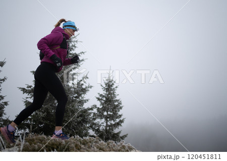 sky running or trail running woman exercising on a mountain top 120451811