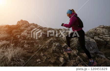 trail running woman athlete training for ultra-marathon race in a mountain trail running woman athlete training for ultra-marathon race in a mountain 120451829