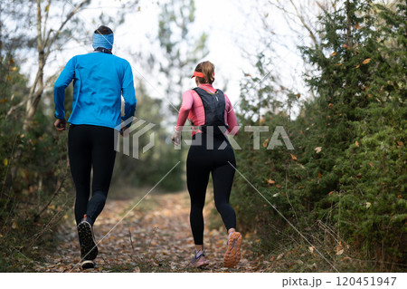 trail running with a sporty couple in the magic forest in early morning trail running with a sporty couple in the magic forest in early morning 120451947
