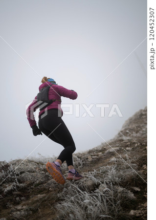 trail running woman athlete training for ultra-marathon race in a mountain trail running woman athlete training for ultra-marathon race in a mountain 120452307