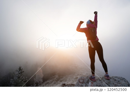 woman man standing on top of a mountain as the sun sets. Goals and achievements concept photo composite woman man standing on top of a mountain as the sun sets. Goals and achievements concept photo composite 120452500