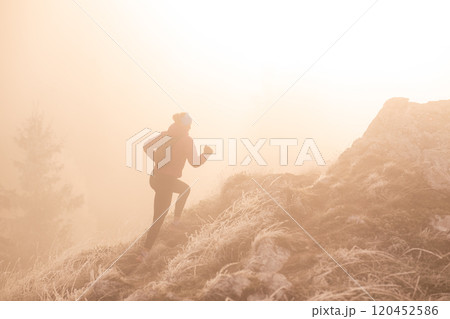 trail running woman athlete training for ultra-marathon race in a mountain 120452586