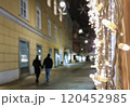 People walking on a street with beautiful Christmas decorations at night, in the city center of Graz, Styria region, Austria. Selective focus 120452985